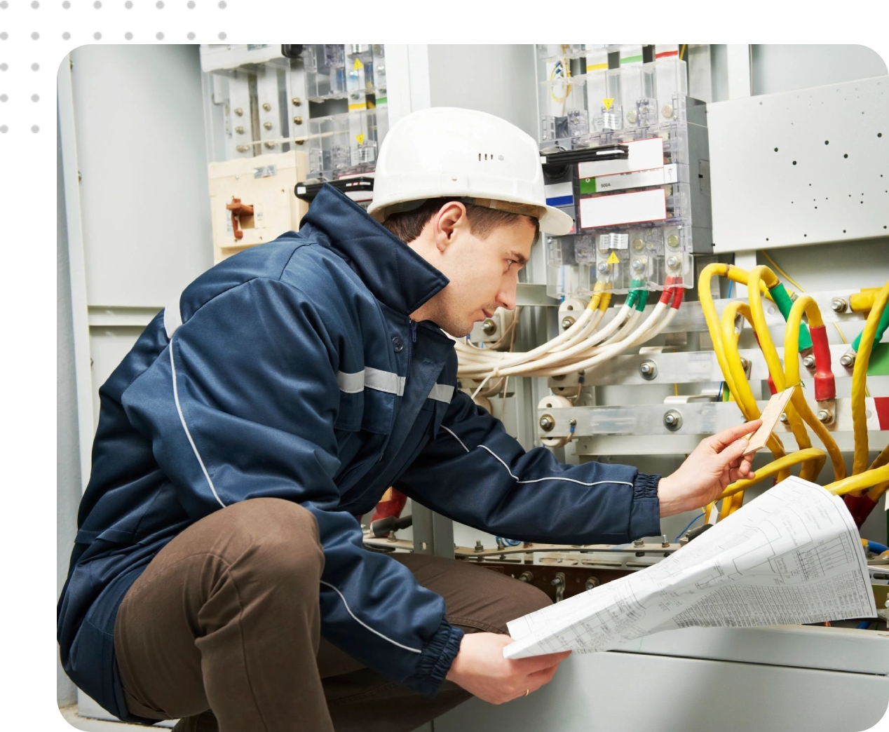 Electrician inspecting electrical panel diagrams.