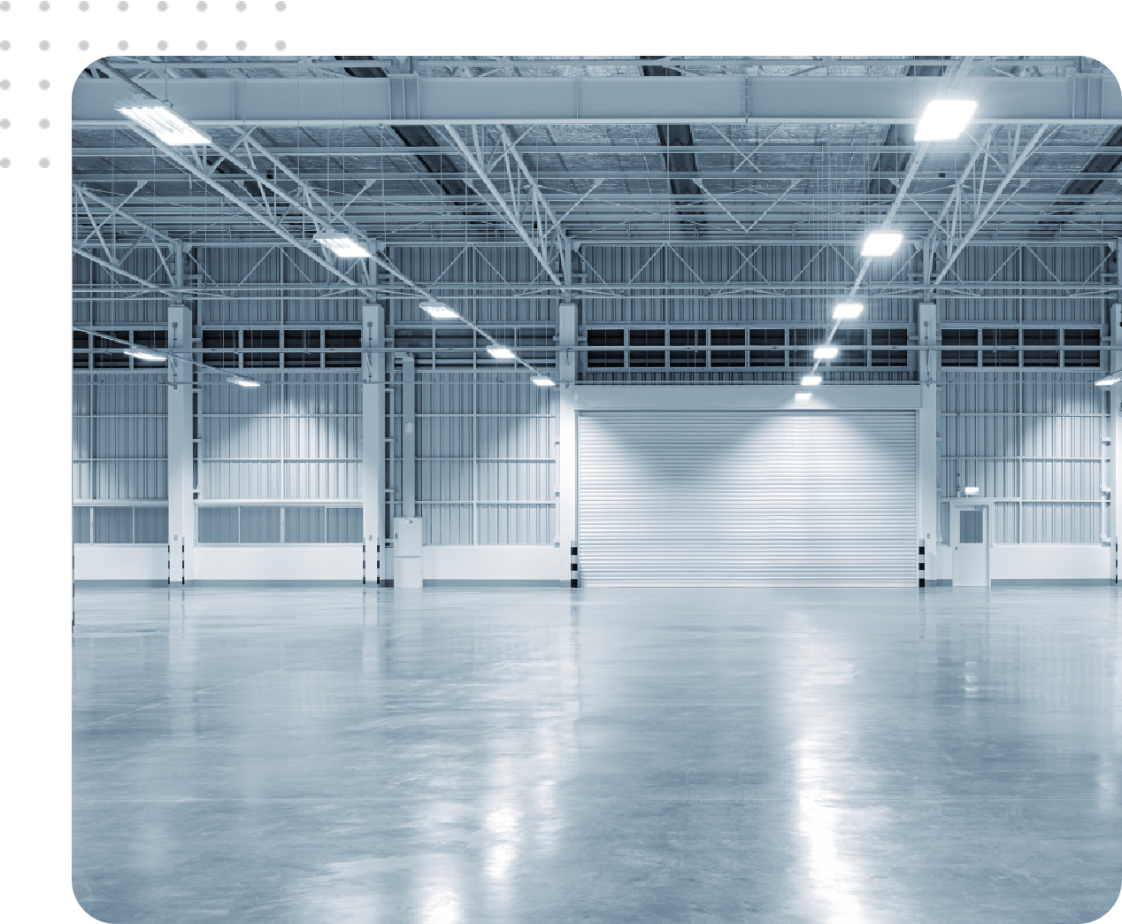 Empty warehouse with large roll-up door.