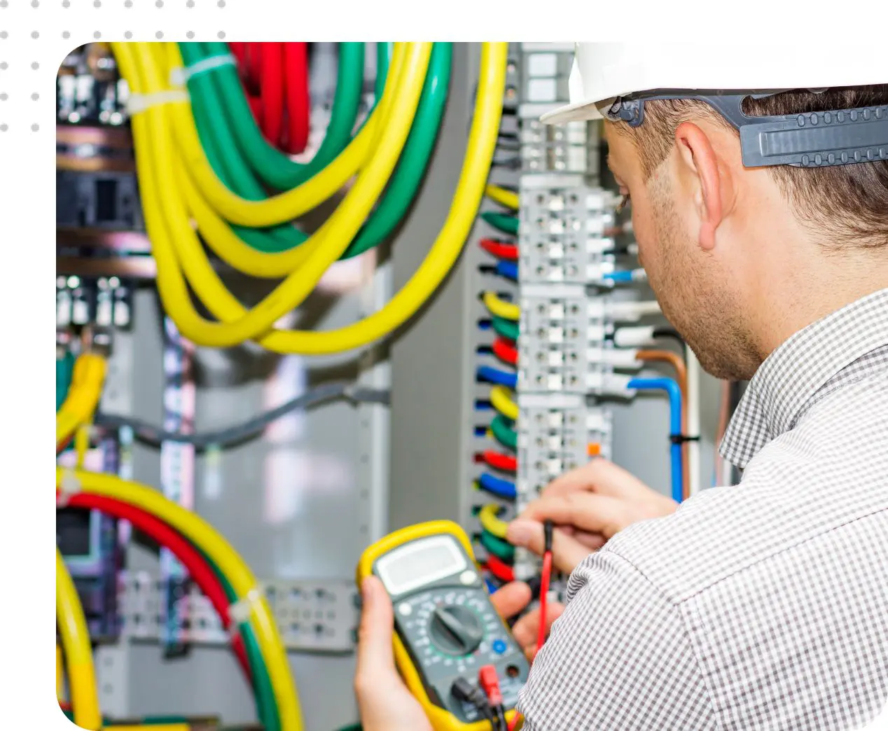 Electrician testing electrical panel wiring.