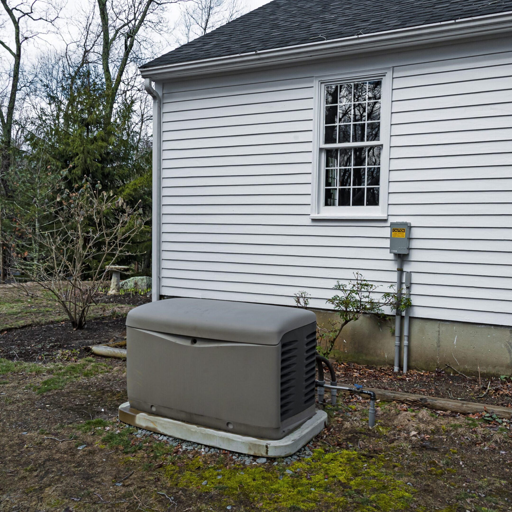 Home standby generator outside house.