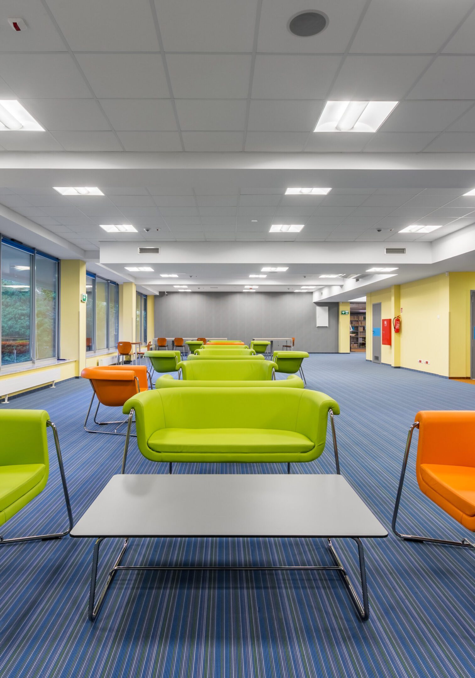 Modern library lounge with colorful chairs.